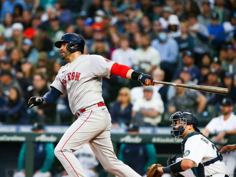 Jun 11, 2022; Seattle, Washington, USA;  Boston Red Sox designated hitter J.D. Martinez (28) follows through on a two-run home run against the Seattle Mariners during the fifth inning at T-Mobile Park. Mandatory Credit: Lindsey Wasson-USA TODAY Sports