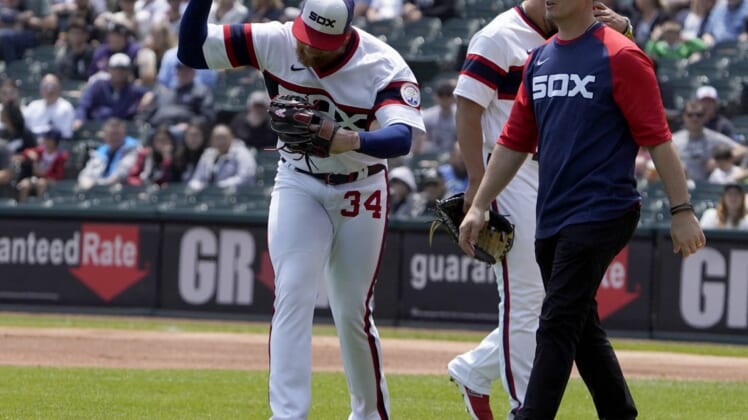 Jun 12, 2022; Chicago, Illinois, USA; Chicago White Sox starting pitcher Michael Kopech (34) reacts after injuring himself against the Texas Rangers during the first inning at Guaranteed Rate Field. Mandatory Credit: David Banks-USA TODAY Sports