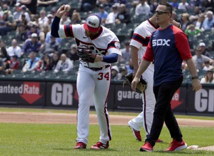 Jun 12, 2022; Chicago, Illinois, USA; Chicago White Sox starting pitcher Michael Kopech (34) reacts after injuring himself against the Texas Rangers during the first inning at Guaranteed Rate Field. Mandatory Credit: David Banks-USA TODAY Sports