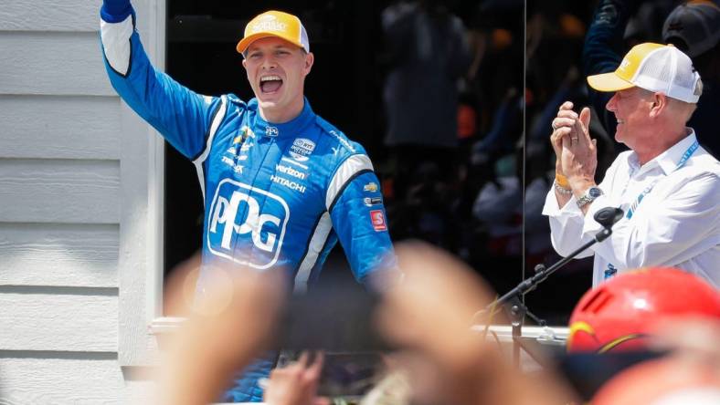 Josef Newgarden raises his arm in victory when he is introduced following his win in the Sonsio Grand Prix, Sunday, June 12, 2022, at Road America near Elkhart Lake, Wis.