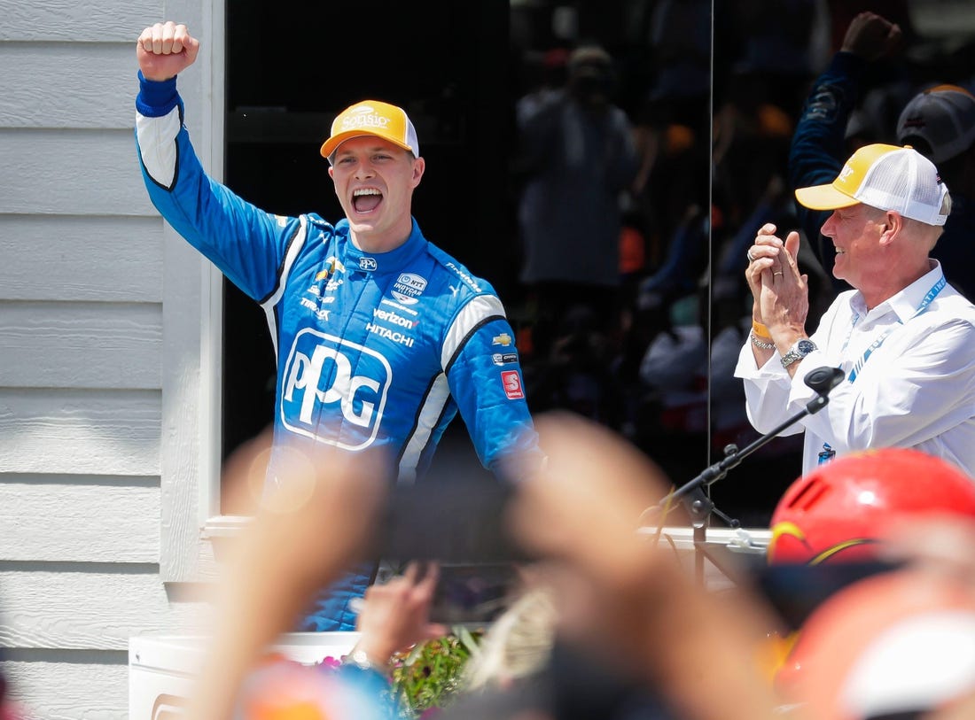 Josef Newgarden raises his arm in victory when he is introduced following his win in the Sonsio Grand Prix, Sunday, June 12, 2022, at Road America near Elkhart Lake, Wis.