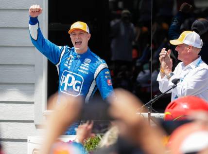 Josef Newgarden raises his arm in victory when he is introduced following his win in the Sonsio Grand Prix, Sunday, June 12, 2022, at Road America near Elkhart Lake, Wis.