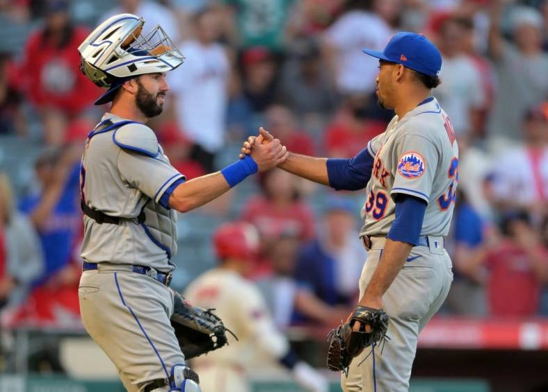 Jun 12, 2022; Anaheim, California, USA; New York Mets relief pitcher Edwin Diaz (39) shakes hands with New York Mets catcher Tomas Nido (3) after the final out of the ninth inning defeating the Los Angeles Angels at Angel Stadium. Mandatory Credit: Jayne Kamin-Oncea-USA TODAY Sports