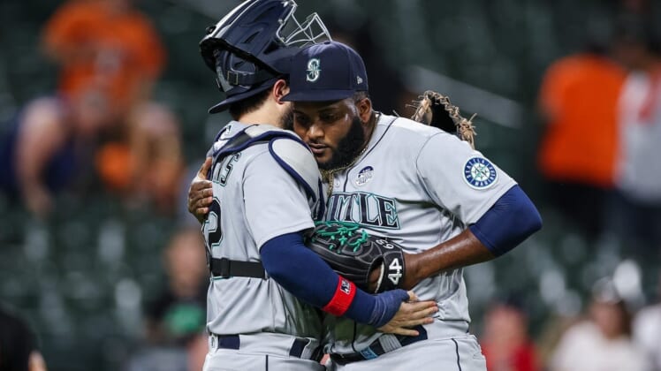 Jun 2, 2022; Baltimore, Maryland, USA; Seattle Mariners catcher Luis Torrens (22) celebrates with relief pitcher Diego Castillo (63) after the final pitch of the game against the Baltimore Orioles at Oriole Park at Camden Yards. Mandatory Credit: Scott Taetsch-USA TODAY Sports
