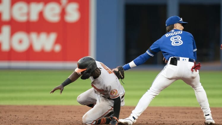 Jun 13, 2022; Toronto, Ontario, CAN; Baltimore Orioles shortstop Jorge Mateo (3) is tagged out by Toronto Blue Jays second baseman Cavan Biggio (8) during the third inning at Rogers Centre. Mandatory Credit: Nick Turchiaro-USA TODAY Sports