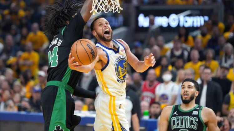 Jun 13, 2022; San Francisco, California, USA; Golden State Warriors guard Stephen Curry (30) goes to the basket while defended by Boston Celtics center Robert Williams III (44) during the first half in game five of the 2022 NBA Finals at Chase Center. Mandatory Credit: Kyle Terada-USA TODAY Sports