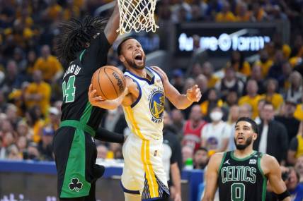 Jun 13, 2022; San Francisco, California, USA; Golden State Warriors guard Stephen Curry (30) goes to the basket while defended by Boston Celtics center Robert Williams III (44) during the first half in game five of the 2022 NBA Finals at Chase Center. Mandatory Credit: Kyle Terada-USA TODAY Sports