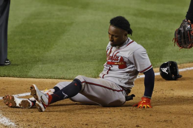 Jun 13, 2022; Washington, District of Columbia, USA; Atlanta Braves third baseman Ozzie Albies (1) sits at the batter's box after being injured while batting against the Washington Nationals during the fifth inning at Nationals Park. Mandatory Credit: Geoff Burke-USA TODAY Sports