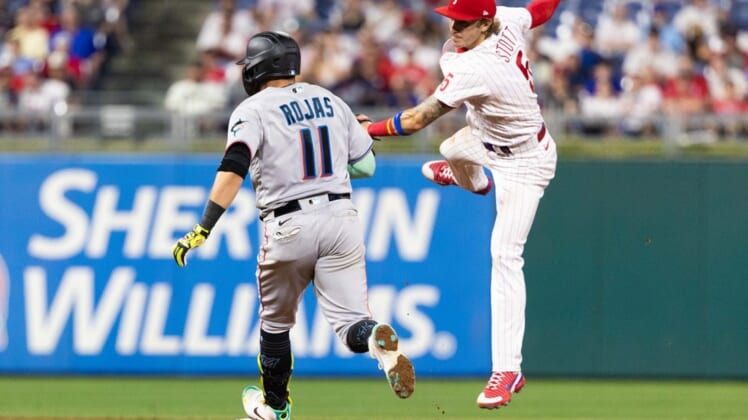 Jun 13, 2022; Philadelphia, Pennsylvania, USA; Miami Marlins shortstop Miguel Rojas (11) reaches second base on an RBI double in front of Philadelphia Phillies third baseman Bryson Stott (5) during the seventh inning at Citizens Bank Park. Mandatory Credit: Bill Streicher-USA TODAY Sports