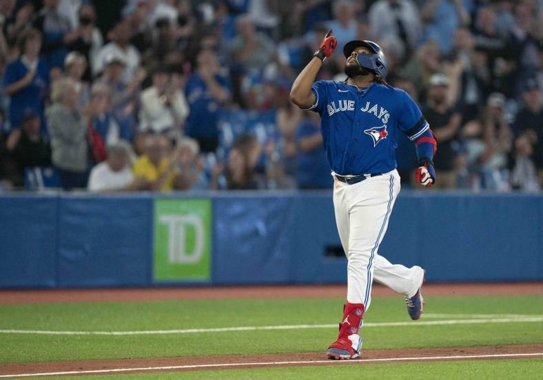 Jun 13, 2022; Toronto, Ontario, CAN; Toronto Blue Jays first baseman Vladimir Guerrero Jr. (27) celebrates as he runs the bases after hitting a solo home run against the Baltimore Orioles during the eighth inning at Rogers Centre. Mandatory Credit: Nick Turchiaro-USA TODAY Sports