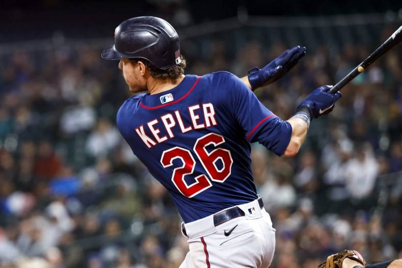 Jun 13, 2022; Seattle, Washington, USA; Minnesota Twins right fielder Max Kepler (26) hits an RBI-single against the Seattle Mariners during the seventh inning at T-Mobile Park. Mandatory Credit: Joe Nicholson-USA TODAY Sports
