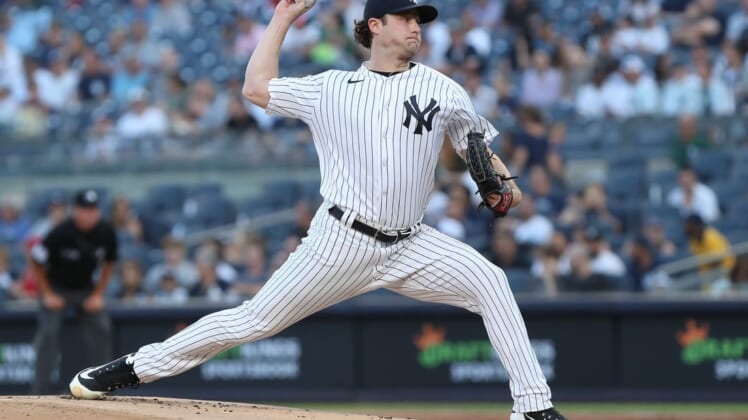 Jun 14, 2022; Bronx, New York, USA; New York Yankees starting pitcher Gerrit Cole (45) pitches the ball against the Tampa Bay Rays during the first inning at Yankee Stadium. Mandatory Credit: Tom Horak-USA TODAY Sports