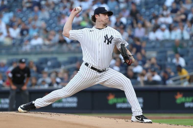 Jun 14, 2022; Bronx, New York, USA; New York Yankees starting pitcher Gerrit Cole (45) pitches the ball against the Tampa Bay Rays during the first inning at Yankee Stadium. Mandatory Credit: Tom Horak-USA TODAY Sports