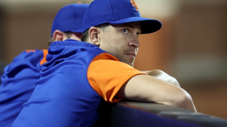 Jun 14, 2022; New York City, New York, USA; New York Mets injured pitcher Jacob deGrom looks out of the dugout during the eighth inning against the Milwaukee Brewers at Citi Field. Mandatory Credit: Brad Penner-USA TODAY Sports