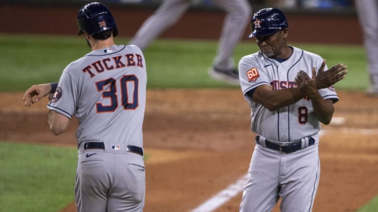 Jun 14, 2022; Arlington, Texas, USA; Houston Astros right fielder Kyle Tucker (30) and third base coach Gary Pettis (8) celebrate after Tucker hits a game winning two run home run against the Texas Rangers during the eighth inning at Globe Life Field. Mandatory Credit: Jerome Miron-USA TODAY Sports