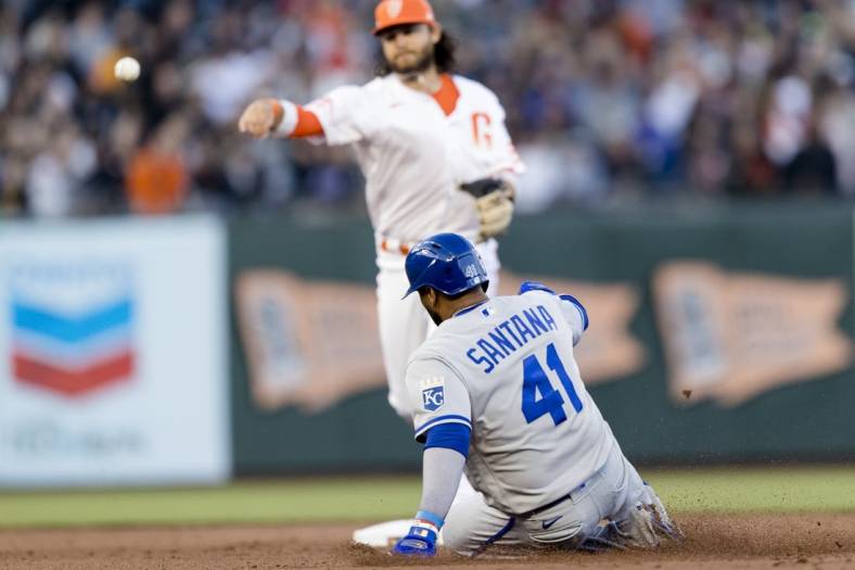 Jun 14, 2022; San Francisco, California, USA; Kansas City Royals first baseman Carlos Santana (41) is tagged out by San Francisco Giants shortstop Brandon Crawford (35) in the first part of a double play during the fifth inning at Oracle Park. Mandatory Credit: John Hefti-USA TODAY Sports