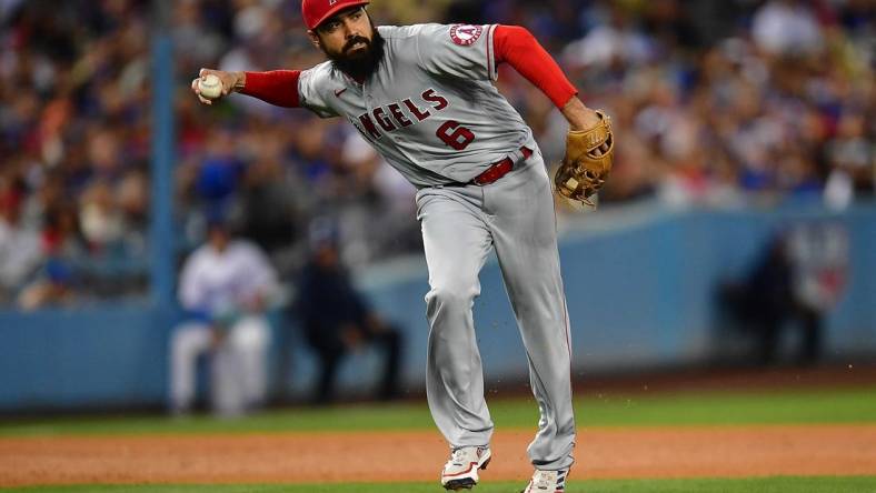 Jun 14, 2022; Los Angeles, California, USA; Los Angeles Angels third baseman Anthony Rendon (6) throws to first after fielding the ball hit for a single by Los Angeles Dodgers shortstop Trea Turner (6) during the fourth inning at Dodger Stadium. Mandatory Credit: Gary A. Vasquez-USA TODAY Sports