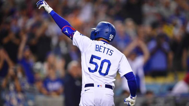 Jun 14, 2022; Los Angeles, California, USA; Los Angeles Dodgers right fielder Mookie Betts (50) celebrates his solo home run hit against the Los Angeles Angels during the eighth inning at Dodger Stadium. Mandatory Credit: Gary A. Vasquez-USA TODAY Sports