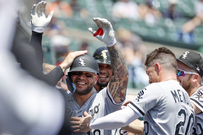 Jun 15, 2022; Detroit, Michigan, USA; Chicago White Sox third baseman Yoan Moncada (10) receives congratulations from teammatesnafter after he hit a three run home run against the Detroit Tigers in the first inning at Comerica Park. Mandatory Credit: Rick Osentoski-USA TODAY Sports