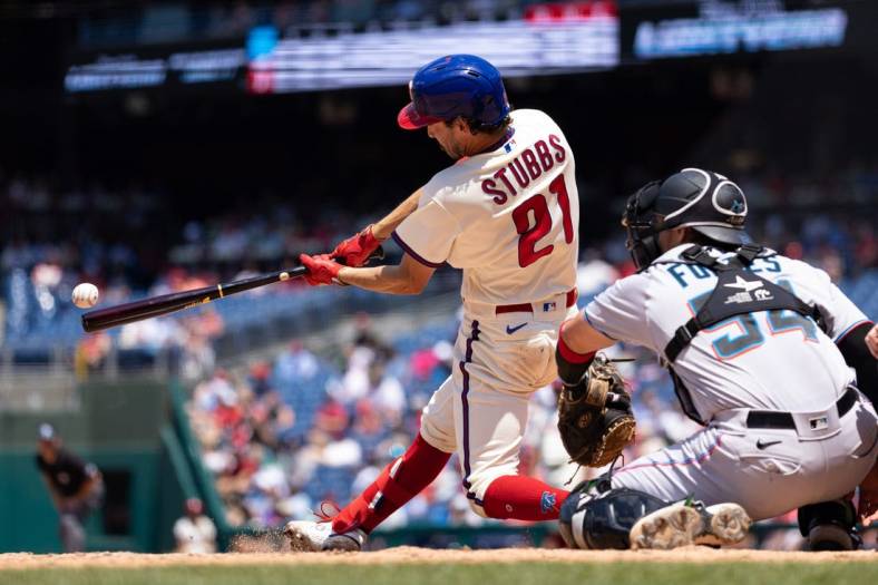 Jun 15, 2022; Philadelphia, Pennsylvania, USA; Philadelphia Phillies catcher Garrett Stubbs (21) hits a double in front of Miami Marlins catcher Nick Fortes (54) during the third inning at Citizens Bank Park. Mandatory Credit: Bill Streicher-USA TODAY Sports