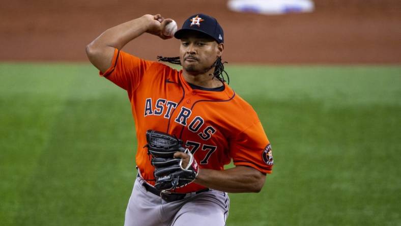 Jun 15, 2022; Arlington, Texas, USA; Houston Astros starting pitcher Luis Garcia (77) pitches against the Texas Rangers during the first inning at Globe Life Field. Mandatory Credit: Jerome Miron-USA TODAY Sports