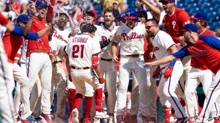 Jun 15, 2022; Philadelphia, Pennsylvania, USA; Philadelphia Phillies catcher Garrett Stubbs (21) is mobbed at home plate by his team after hitting a game winning walk off three RBI home run during the ninth inning against the Miami Marlins at Citizens Bank Park. Mandatory Credit: Bill Streicher-USA TODAY Sports