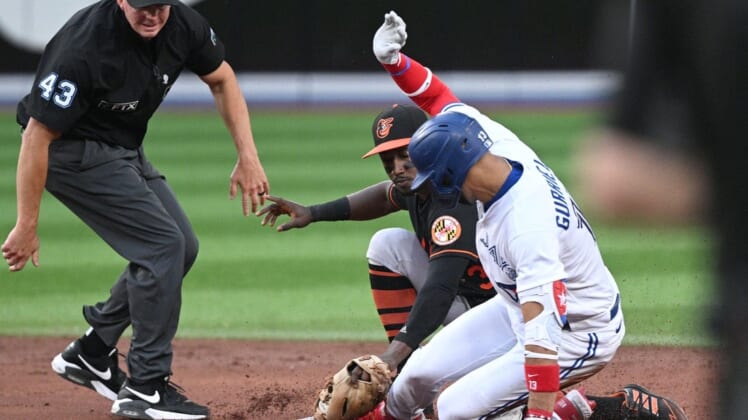 Jun 15, 2022; Toronto, Ontario, CAN;  Toronto Blue Jays left fielder Lourdes Gurriel Jr. (13) is tagged out at second base by Baltimore Orioles shortstop Jorge Mateo (3) in the third inning at Rogers Centre. Mandatory Credit: Dan Hamilton-USA TODAY Sports