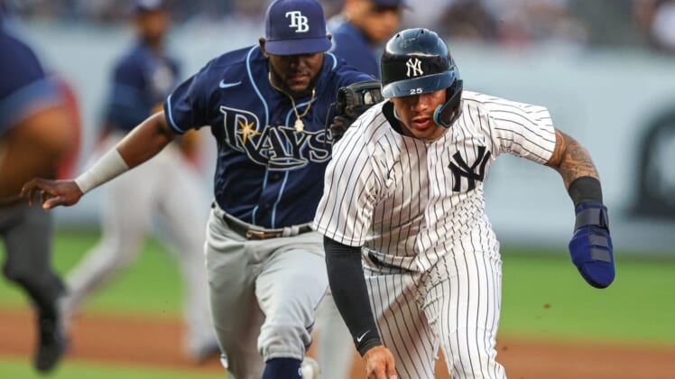 Jun 15, 2022; Bronx, New York, USA; New York Yankees second baseman Gleyber Torres (25) is tagged out during a run down by Tampa Bay Rays second baseman Vidal Brujan (7) during the second inning at Yankee Stadium. Mandatory Credit: Vincent Carchietta-USA TODAY Sports