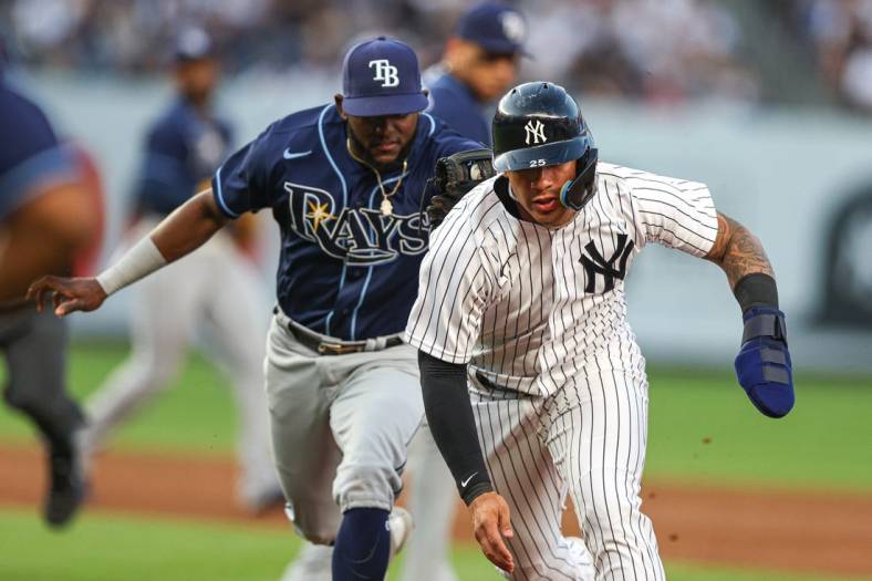 Jun 15, 2022; Bronx, New York, USA; New York Yankees second baseman Gleyber Torres (25) is tagged out during a run down by Tampa Bay Rays second baseman Vidal Brujan (7) during the second inning at Yankee Stadium. Mandatory Credit: Vincent Carchietta-USA TODAY Sports