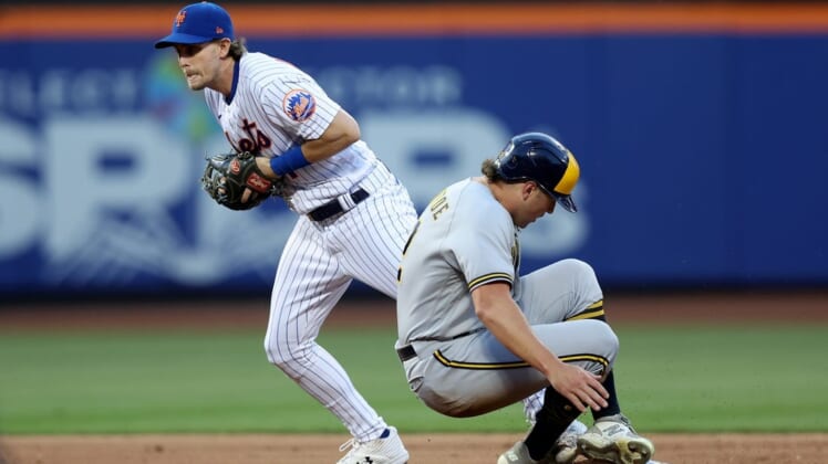 Jun 15, 2022; New York City, New York, USA; Milwaukee Brewers right fielder Hunter Renfroe (12) is forced out at second base by New York Mets second baseman Jeff McNeil (1) on a double play ball hit by Brewers third baseman Luis Urias (not pictured) during the third inning at Citi Field. Mandatory Credit: Brad Penner-USA TODAY Sports