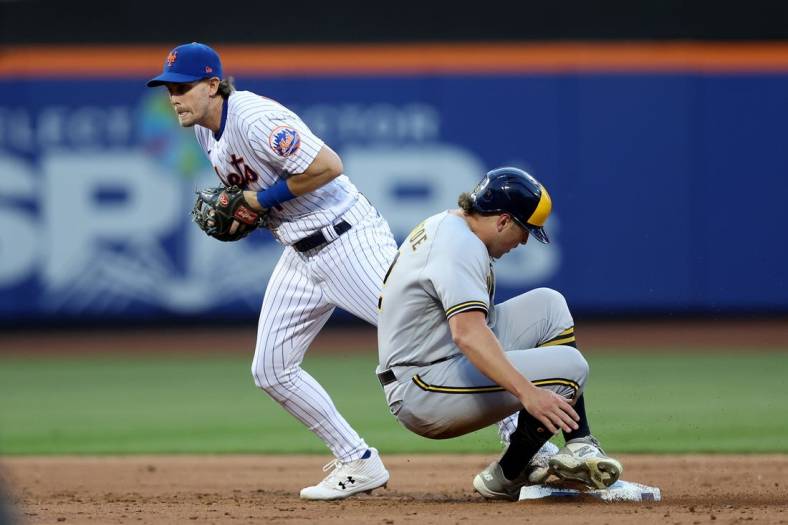 Jun 15, 2022; New York City, New York, USA; Milwaukee Brewers right fielder Hunter Renfroe (12) is forced out at second base by New York Mets second baseman Jeff McNeil (1) on a double play ball hit by Brewers third baseman Luis Urias (not pictured) during the third inning at Citi Field. Mandatory Credit: Brad Penner-USA TODAY Sports