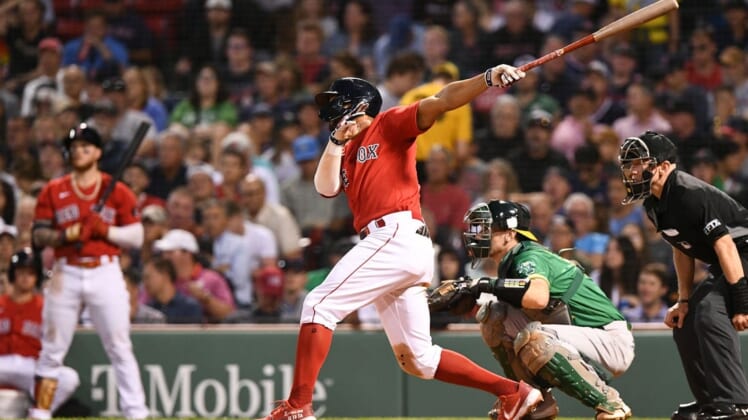 Jun 15, 2022; Boston, Massachusetts, USA; Boston Red Sox shortstop Xander Bogaerts (2) hits a RBI against the Oakland Athletics during the fourth inning at Fenway Park. Mandatory Credit: Brian Fluharty-USA TODAY Sports