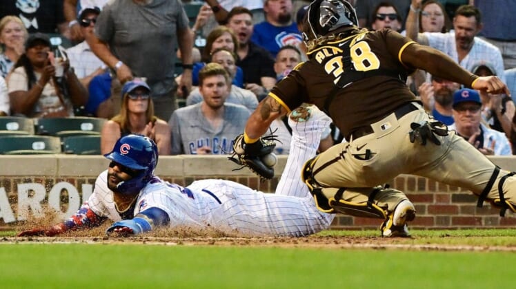 Jun 15, 2022; Chicago, Illinois, USA; Chicago Cubs second baseman Jonathan Villar (24) beats the tag from San Diego Padres catcher Jorge Alfaro (38) to score in the second inning at Wrigley Field. Mandatory Credit: Quinn Harris-USA TODAY Sports