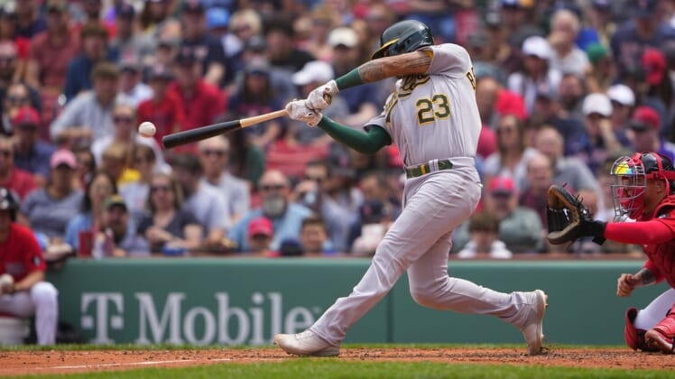 Jun 16, 2022; Boston, Massachusetts, USA; Oakland Athletics catcher Christian Bethancourt (23) hits an RBI single against the Boston Red Sox during the third inning at Fenway Park. Mandatory Credit: Gregory Fisher-USA TODAY Sports