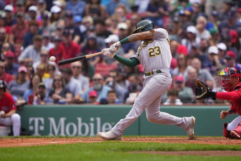 Jun 16, 2022; Boston, Massachusetts, USA; Oakland Athletics catcher Christian Bethancourt (23) hits an RBI single against the Boston Red Sox during the third inning at Fenway Park. Mandatory Credit: Gregory Fisher-USA TODAY Sports