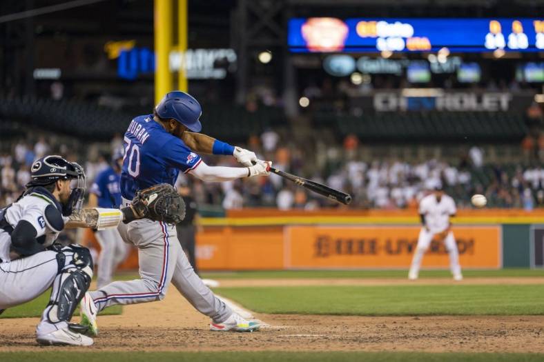 Jun 16, 2022; Detroit, Michigan, USA; Texas Rangers third baseman Ezequiel Duran (70) hits a RBI triple against Detroit Tigers starting pitcher Gregory Soto (not pictured) during the ninth inning at Comerica Park. Mandatory Credit: Raj Mehta-USA TODAY Sports