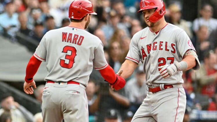 Jun 16, 2022; Seattle, Washington, USA; Los Angeles Angels center fielder Mike Trout (27) and right fielder Taylor Ward (3) celebrate at home plate after Trout hit a two-run home run against the Seattle Mariners during the third inning at T-Mobile Park. Mandatory Credit: Steven Bisig-USA TODAY Sports