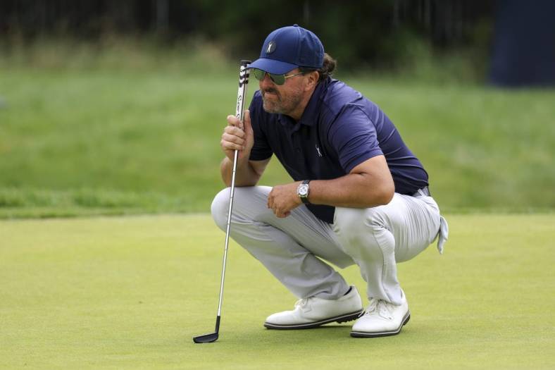 Jun 17, 2022; Brookline, Massachusetts, USA; Phil Mickelson lines up a putt on the 17th green during the second round of the U.S. Open golf tournament at The Country Club. Mandatory Credit: Aaron Doster-USA TODAY Sports