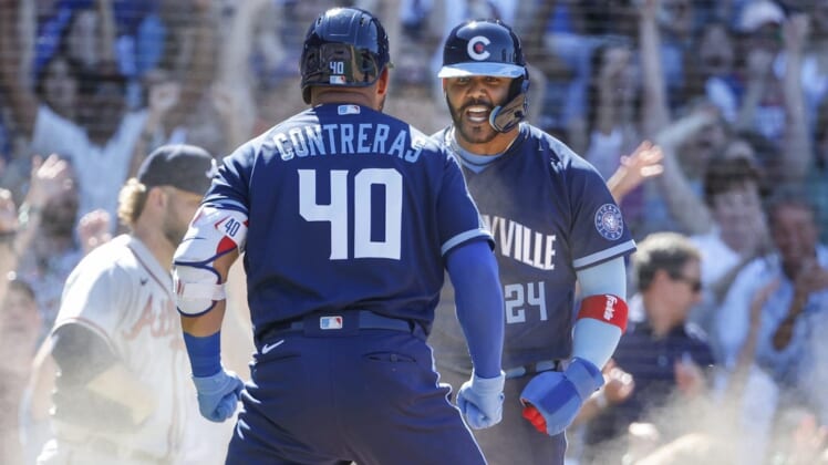 Jun 17, 2022; Chicago, Illinois, USA; Chicago Cubs second baseman Jonathan Villar (24) celebrates with designated hitter Willson Contreras (40) after scoring against the Atlanta Braves during the eight inning at Wrigley Field. Mandatory Credit: Kamil Krzaczynski-USA TODAY Sports