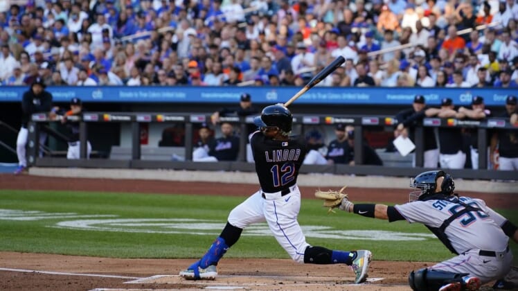Jun 17, 2022; New York City, New York, USA; New York Mets shortstop Francisco Lindor (12) hits a three run home run against the Miami Marlins during the first inning at Citi Field. Mandatory Credit: Gregory Fisher-USA TODAY Sports