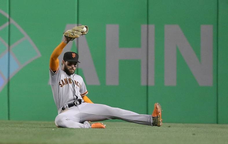 Jun 17, 2022; Pittsburgh, Pennsylvania, USA; San Francisco Giants right fielder Luis Gonzalez (51) makes a sliding catch for an out against Pittsburgh Pirates shortstop Diego Castillo (not pictured) during the eighth inning at PNC Park. Mandatory Credit: Charles LeClaire-USA TODAY Sports