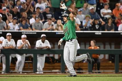 Jun 17, 2022; Omaha, NE, USA; Notre Dame Fighting Irish first baseman Carter Putz (4) rounds the bases after hitting a home run in the ninth inning against the Texas Longhorns at Charles Schwab Field. Mandatory Credit: Steven Branscombe-USA TODAY Sports