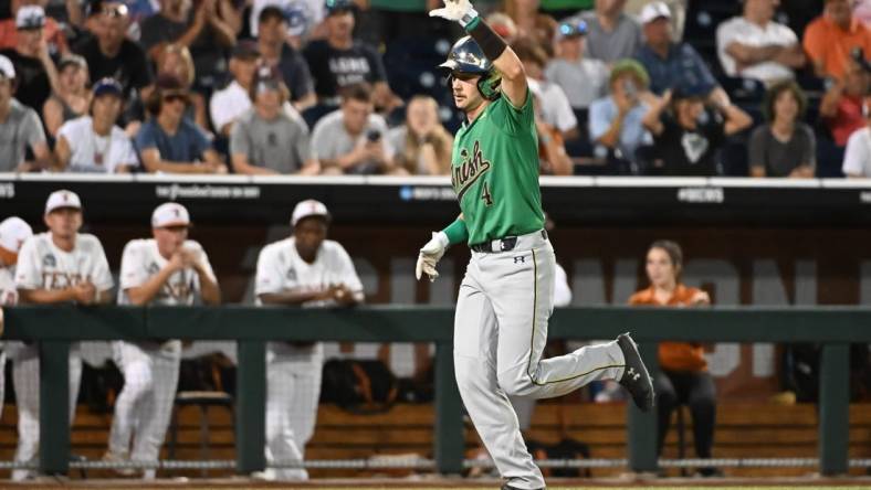 Jun 17, 2022; Omaha, NE, USA; Notre Dame Fighting Irish first baseman Carter Putz (4) rounds the bases after hitting a home run in the ninth inning against the Texas Longhorns at Charles Schwab Field. Mandatory Credit: Steven Branscombe-USA TODAY Sports