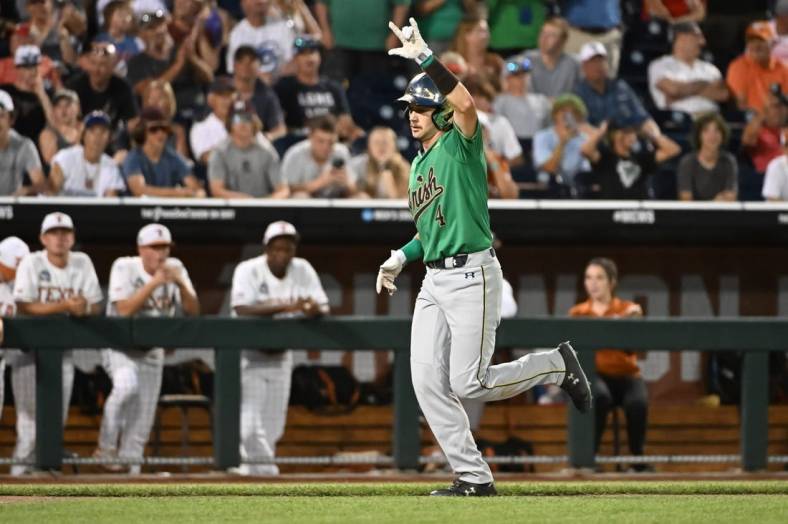 Jun 17, 2022; Omaha, NE, USA; Notre Dame Fighting Irish first baseman Carter Putz (4) rounds the bases after hitting a home run in the ninth inning against the Texas Longhorns at Charles Schwab Field. Mandatory Credit: Steven Branscombe-USA TODAY Sports