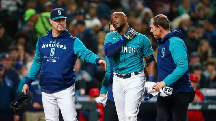 Jun 17, 2022; Seattle, Washington, USA; Seattle Mariners left fielder Justin Upton (8) is walked off the field by manager Scott Servais after being hit by a pitch against the Los Angeles Angels during the fifth inning at T-Mobile Park. Upton would leave the game and be replaced by left fielder Dylan Moore. Mandatory Credit: Lindsey Wasson-USA TODAY Sports