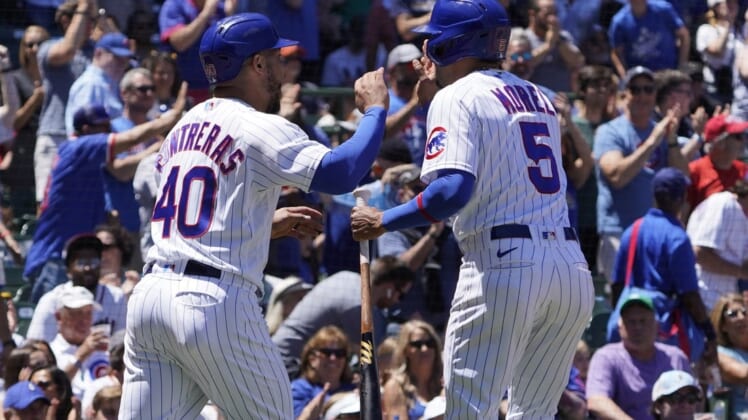 Jun 18, 2022; Chicago, Illinois, USA; Chicago Cubs catcher Willson Contreras (40) and center fielder Christopher Morel (5) celebrate after scoring against the Atlanta Braves during the first inning at Wrigley Field. Mandatory Credit: David Banks-USA TODAY Sports