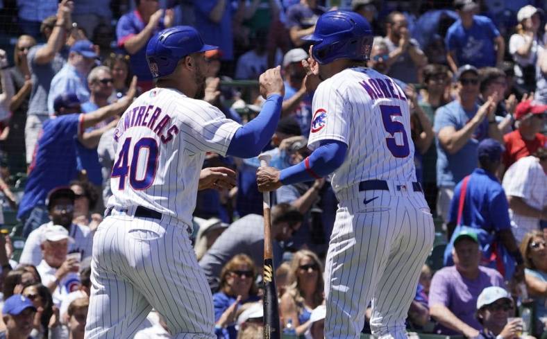 Jun 18, 2022; Chicago, Illinois, USA; Chicago Cubs catcher Willson Contreras (40) and center fielder Christopher Morel (5) celebrate after scoring against the Atlanta Braves during the first inning at Wrigley Field. Mandatory Credit: David Banks-USA TODAY Sports