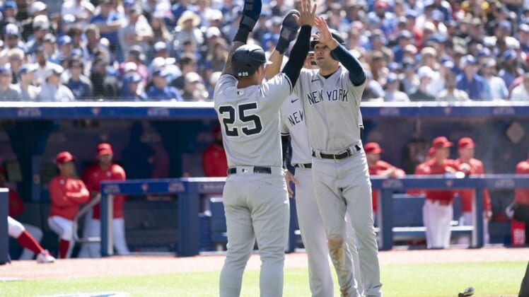 Jun 18, 2022; Toronto, Ontario, CAN; New York Yankees shortstop Isiah Kiner-Falefa (12) celebrates with New York Yankees second baseman Gleyber Torres (25) after scoring runs against the Toronto Blue Jays during the fourth inning at Rogers Centre. Mandatory Credit: Nick Turchiaro-USA TODAY Sports