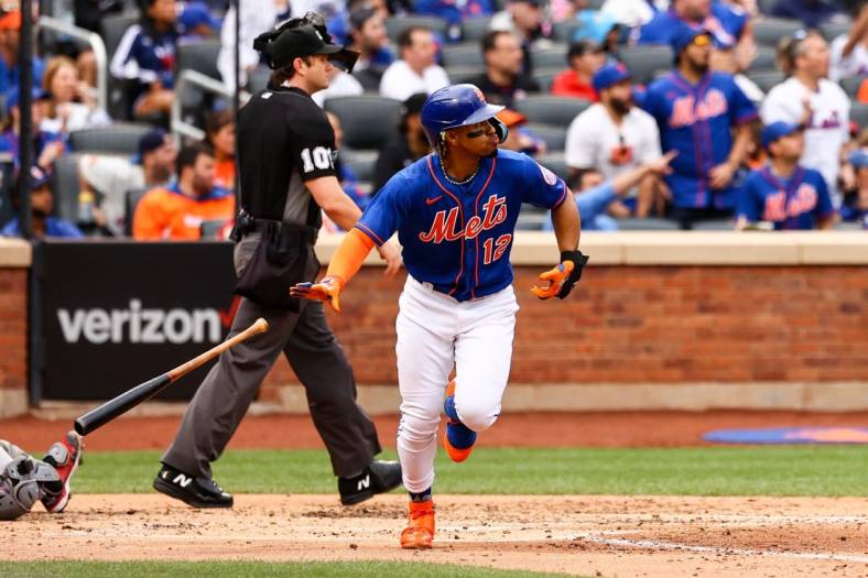 Jun 18, 2022; New York City, New York, USA; New York Mets shortstop Francisco Lindor (12) drops the bat after hitting a two-run home run against the Miami Marlins during the third inning at Citi Field. Mandatory Credit: Jessica Alcheh-USA TODAY Sports