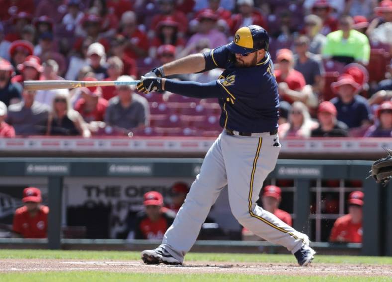 Jun 18, 2022; Cincinnati, Ohio, USA; Milwaukee Brewers first baseman Rowdy Tellez (11) hits an RBI double against the Cincinnati Reds during the first inning at Great American Ball Park. Mandatory Credit: David Kohl-USA TODAY Sports